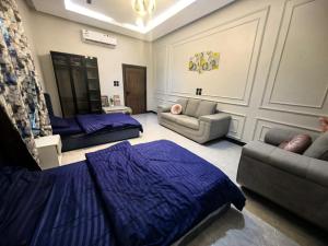 a living room with a bed and a couch at Welcome to Chalet Bonsiana! in Jeddah +45 photos