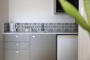 a kitchen with a sink and a counter top at Coastal Calm Papamoa in Tauranga