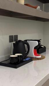a kitchen counter with various appliances on a shelf at شقة بغرفتين نوم وصالة in Hail