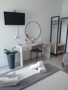 a room with a desk with a mirror and a chair at NaDim rooms in Himare
