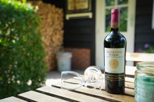a bottle of wine sitting on top of a table at De Kopstoof in Lekkerkerk