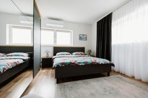 a bedroom with two beds and a mirror at Mia in Livno
