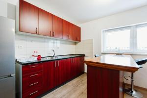 a kitchen with red cabinets and a sink at Mia in Livno +8 photos