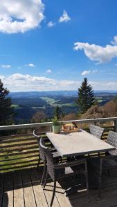 a table and chairs on a deck with a view at Brend Hotel und Gasthof in Furtwangen
