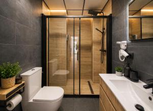 a bathroom with a shower and a toilet and a sink at Ohana Urban Málaga Centro in Málaga