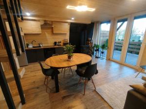 a kitchen and dining room with a table and chairs at Lake House Jeziorsko in Ostrów Warcki