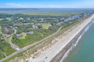 an aerial view of a beach and the ocean at Castaway by Oak Island Accommodations in Caswell Beach
