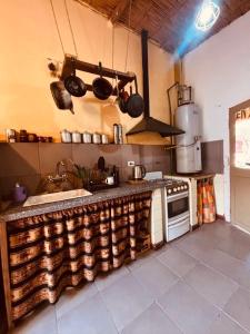 a kitchen with a counter and a stove in it at El Farolo in Tilcara +23 photos