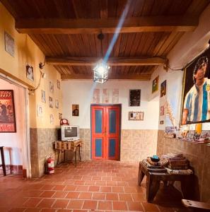 a room with a red door in a building at El Farolo in Tilcara