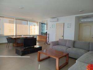 a living room with a couch and a table at Banderas Suites in Bucerías