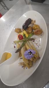 a white plate of food on a table at Brend Hotel und Gasthof in Furtwangen +21 photos