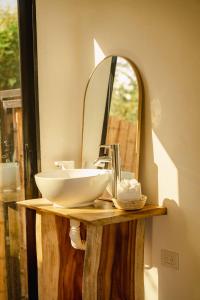 a bathroom with a sink and a mirror at Alma Vita Punta Mango in Jucuarán +28 photos