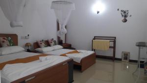 Letto o letti in una camera di Sigiri Regal Residence