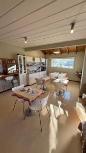 a large room with tables and chairs in it at Del Nomade Hosteria Ecologica in Puerto Pirámides
