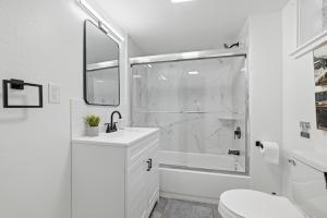 a white bathroom with a shower and a sink at Pittsburgh Millvale A Bright & Cozy Private Bedroom with Shared Bathroom in Pittsburgh +10 photos