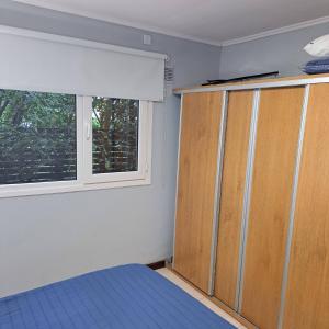 a bedroom with a bed and a window at Rincon de Gulliver in Pinamar +9 photos