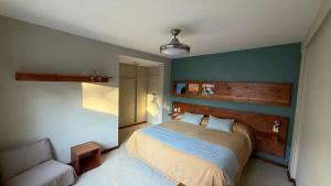 a bedroom with a bed and a couch in it at Del Nomade Hosteria Ecologica in Puerto Pirámides
