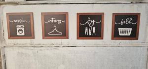 a wall with four chalk signs on it at Aparta estudio campestre in Chía +8 photos