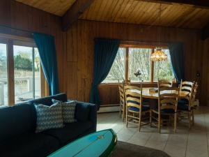 a living room with a couch and a table and chairs at Waterfront Round House View in Oakdale