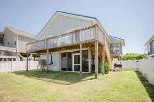 a house with a wrap around porch with a deck at Changes In LAttitude by Oak Island Accommodations in Oak Island +61 photos