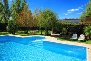 a swimming pool in a yard with a house at MARGAHOME in Maipú