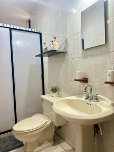 a bathroom with a toilet and a sink at Casa Moderna, Ubicación Estrategjca in Cedro