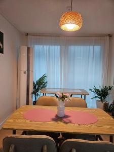a dining room table with a vase of flowers on it at SNU Station 13min, Line 2, Hongdae,Gangnam 30min, 6pax in Seoul