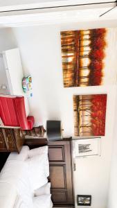 a bedroom with a bed and paintings on the wall at Penn Signature Airport Short Term Rental PHX in Phoenix