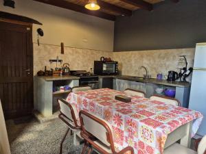 a kitchen with a table with chairs and a counter top at Casa Manipa -3 dormitorios in Cafayate