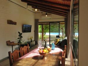 a dining room table with a bowl of fruit on it at MARGAHOME in Maipú