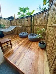 a patio with a hammock and a wooden floor at Pads Guesthouse in San Vicente +2 photos