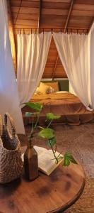a bedroom with a bed and a table with a book at Lahima Cabanas Villa in Dickwella
