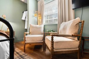 a bedroom with two chairs and a window at LMI -15- Laurel Falls Room: Summers Night in Lookout Mountain