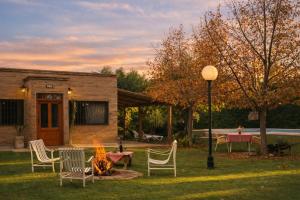 a group of chairs sitting around a fire in a yard at MARGAHOME in Maipú