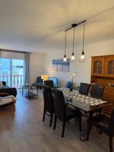 a living room with a table and chairs at Suites Setúbal - River View in Setúbal