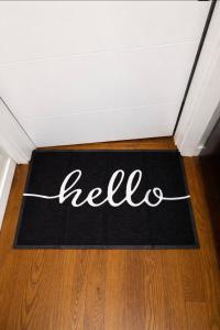 a black and white welcome mat on a floor in a room at Anne Room B in Irvington