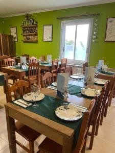 a dining room with tables and chairs and a window at Pensión Restaurante Verdemar in Vigo