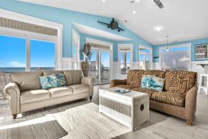 a living room with a couch and a table at Conch Out by Oak Island Accommodations in Oak Island