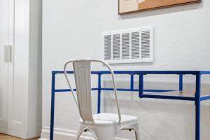 a chair sitting in front of a blue desk at Pittsburgh Millvale E Modern and Quiet Private Bedroom with Shared Bathroom in Pittsburgh