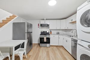 a kitchen with white cabinets and a stove top oven at Pittsburgh Millvale E Modern and Quiet Private Bedroom with Shared Bathroom in Pittsburgh +10 photos