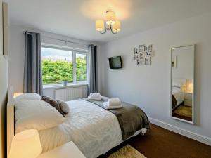 a bedroom with a bed and a large window at 3 Bed in Brixham oc-92770 in Brixham
