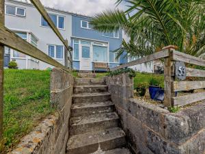 a set of stairs in front of a blue house at 3 Bed in Brixham oc-92770 in Brixham