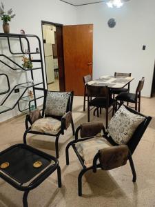 a room with chairs and a table and a table and chairs at Amelia in San Juan