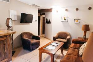 a living room with a couch and chairs and a table at Desert Oasis Condo in Green Valley