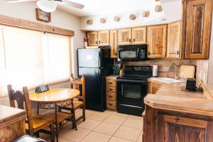 a kitchen with a black refrigerator and a table at Desert Oasis Condo in Green Valley