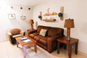 a living room with a brown couch and a chair at Desert Oasis Condo in Green Valley