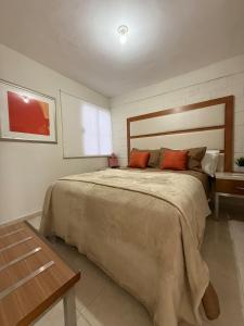 a bedroom with a large bed and a table at Confortable estancia de 1 a 4 personas in Guamúchil