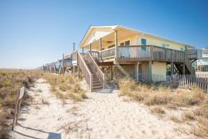 a house on the beach with stairs to the sand at Dip Inn by Oak Island Accommodations in Oak Island