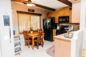 a kitchen with a wooden table and a black refrigerator at Calle Condo in Green Valley