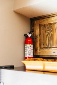 a red fire extinguisher sitting on top of a counter at Calle Condo in Green Valley